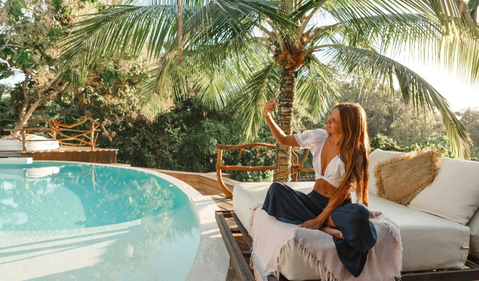 Joyful,And,Happy,Woman,Sitting,On,White,Sofa,Under,Palm Joyful,And,Happy,Woman,Sitting,On,White,Sofa,Under,Palm